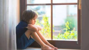 Parent and child separated by parental alienation with legal documents