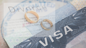 Couple discussing divorce papers with a lawyer, with immigration documents on the table.